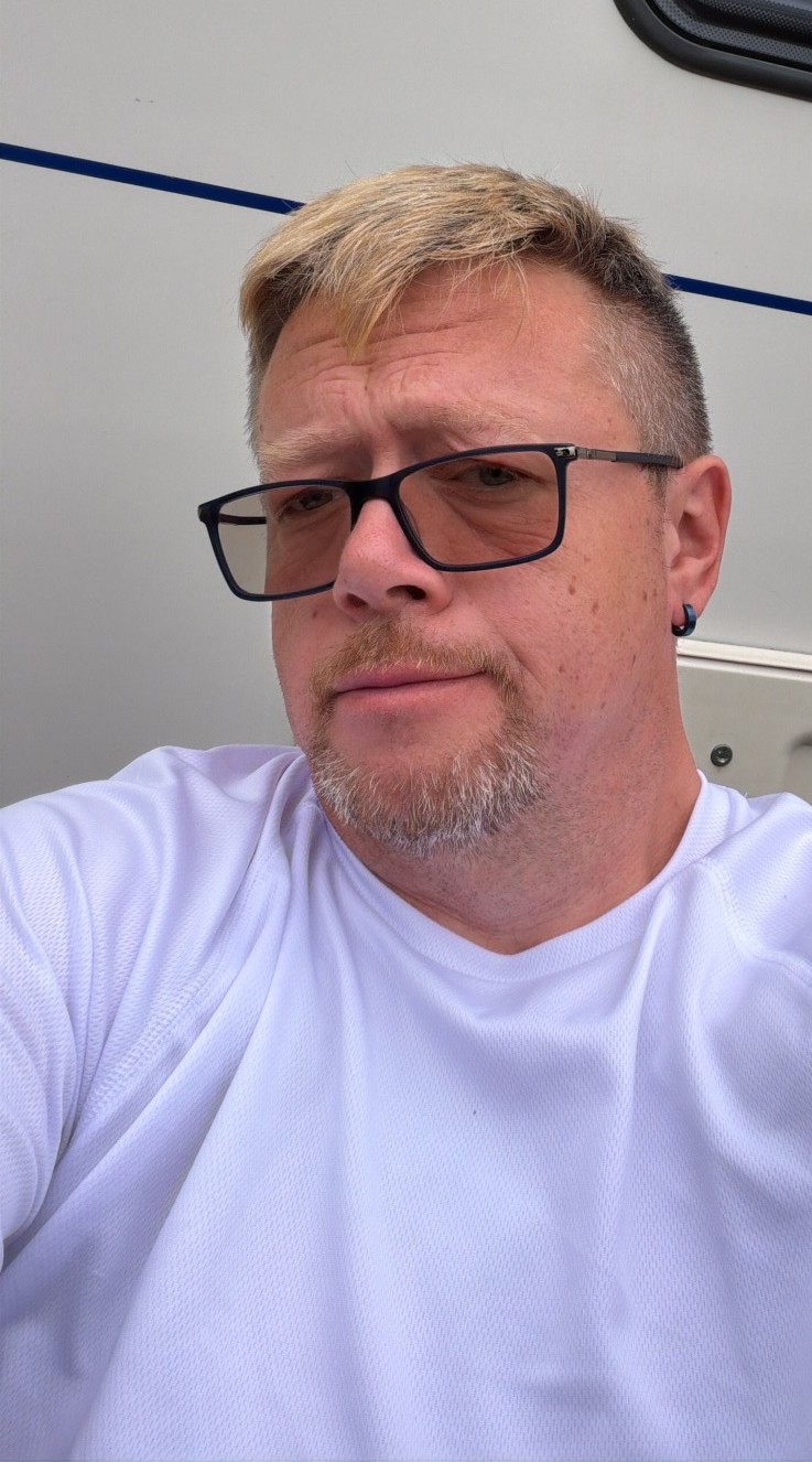 John relaxing beside his caravan
