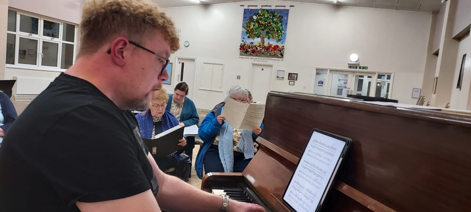 John playing piano at choir rehearsal